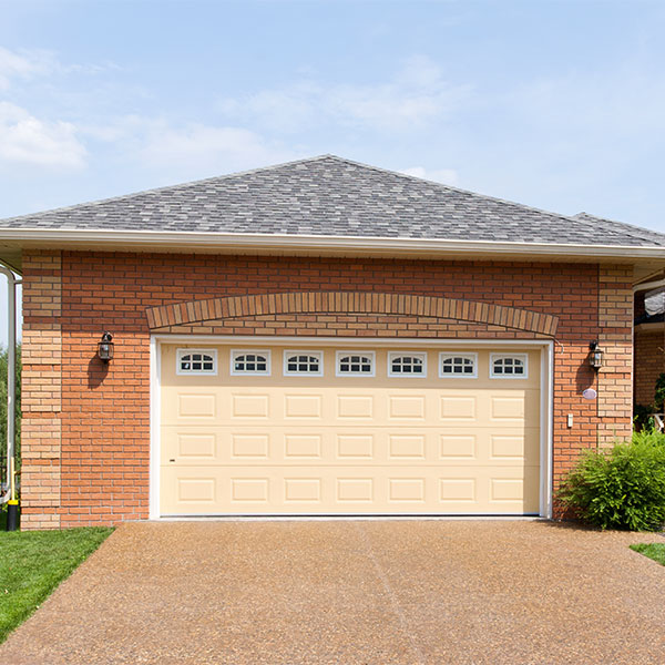 Large brick garage in a suburban environment on a sunny day
